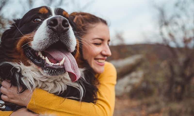 A woman hugging her dog